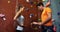 Coach training a woman at bouldering gym 4k