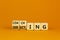 Coaching or directing leadership style symbol. Turned cubes and changed words `directing` to `coaching`. Beautiful orange