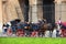 Coachmen sitting on chairs, pulled by a horse in Rome, Italy