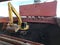 Coal discharging operation by crane`s grab and excavator on bulk ship