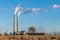 A coal-fired electrical power plant with smokestacks emitting plumes of smoke in the southwestern United States