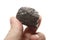 Coal lump carbon nugget in male hand isolated