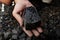 Coal miner in the man hands of coal background. Coal mining or e