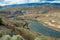 A coal train winds along the Thompson River near Ashcroft, British Columbia, Canada