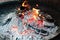 Coals burn in barbecue or bonfire. cooking over open fire