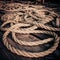 Coarse coconut rope at wooden fishing boat deck under sunset sunlight. Detail of chinese fishing nets at Cochin Kochi. South