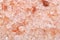 Coarse himalayan pink salt granules macro shot background