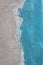 Coarse plaster texture painted blue resembling sea shore as background