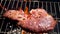 Coarse salt falls on a veal steak on a grill