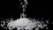 Coarse sea salt crystal falling on black background