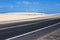 Coast asphalt road. Sunrise on asphalt coat, macro photo of road. Beach way. Highway in Spain.