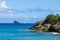 Coast of Base-terre island, lone sailboat in the background