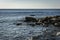 Coast of the Black Sea at sunset. Sea stones and rocks of different sizes and textures