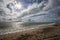 Coast. Dramatic weather sky. Offshore wind farm turbines