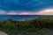 The coast of the Greek island in stormy weather. It`s raining on the horizon