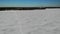 Coast Gulf Lake sea in ice with snow. snow dunes. ski track. Winter Aerial