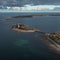 Coast and lighthouse Lange Erik in the north of the island of Öland in the east of Sweden from above in the sun