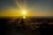 Coast line with lighthouse, dune and rare vegetation in the background at sunset