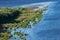 Coast of sea island edge, aerial top view. Densely green jungle peninsula, copy space. Pure, clean and calm blue water. Virgin