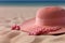 Coastal accessory A beach sand backdrop with a pink straw hat