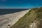 Coastal area in Lithuania Coastal scenery with sandy beach, dunes with marram grass and rough sea on a clear summer day