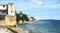 Coastal area with old stone buildings. Ocean shore