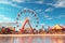 Coastal carnival with colorful Ferris wheel and. Generative ai