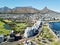 Coastal city with a bustling boardwalk and beach: Cape Town