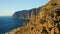 Coastal city Puerto Santiago with Los Gigantes cliffs in deep ocean water. Famous tourist destination. Tenerife.