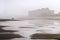 Coastal city reflected in the beach