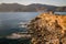 Coastal cliff with ruins of watch tower, Sardinia