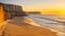 Coastal cliffs casting long shadows on the beach as the sun dips below the horizon