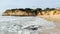 Coastal cliffs and foamy surf of the Atlantic Ocean at Armacao de Pera, Algarve, Portugal