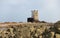 A coastal defence tower on a low tide rocky island