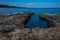 Coastal erosion ,hole in rocky beach in the shape of a heart ,saint florent ,corsica concept of romatic holidays