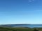 Coastal fields with a clear sky by the sea