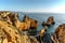 Coastal golden cliffs at sunrise in Ponta da Piedade near Lagos,Portugal.Spectacular rock formations with caves, grottoes and sea