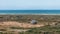 Coastal house in wide grass field with beautiful view of the sea in the port town of Skagen, Denmark