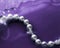 Coastal jewellery fashion, pearl necklace under purple water background, glamour style present and chic gift for luxury jewelery