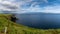 Coastal landscape with green meadows and rugged cliffs on a beautiful summer day on the Dingle Peninsula of County Kerry in