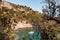 Coastal landscape with rocky hills and trees. Boat or yacht sailing on the shore on Costa Brava in Spain