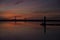 Coastal landscape after sunset in blue hour with two people contemplating the horizon