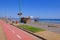 Coastal Pacific beach promenade with paved bike path and sandy beach, San Antonio, Valparaiso region, Chile