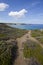 Coastal path leads to a blue sea