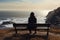 Coastal serenity lone girl in black on cliff bench, contemplating