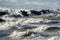 Coastal storm in the Baltic Sea, big waves crash against the harbor breakwater, breaking wave