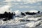 Coastal storm in the Baltic Sea, big waves crash against the harbor breakwater, breaking wave