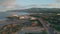 Coastal town morning light aerial view. Peaceful waves meeting sand shore scene.