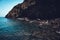 Coastal view of a rocky shore being washed by the waters of a calm sea