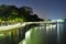 A coastal walkway by night with reflection